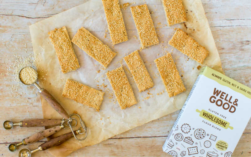 Gluten free sesame crackers next to wholesome flour
